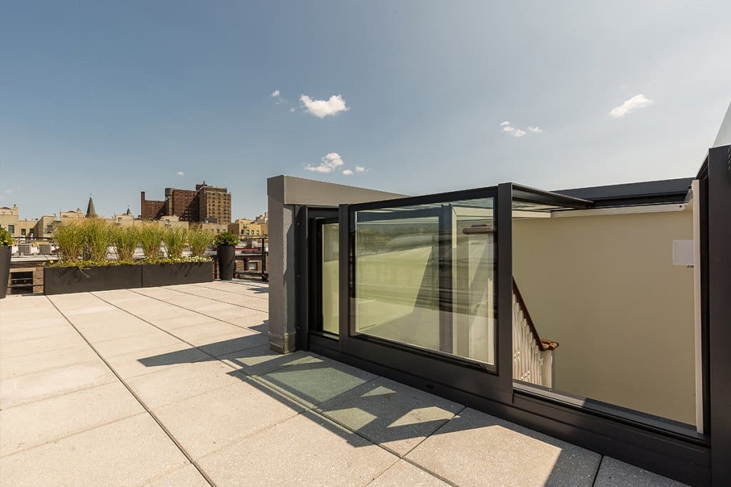 Roof deck view of our sliding box skylights on West 138 Street, Harlem for roof access.