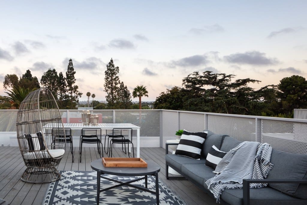 Roof deck of homes in Culver City, LA that feature a dining area and a lounging area.