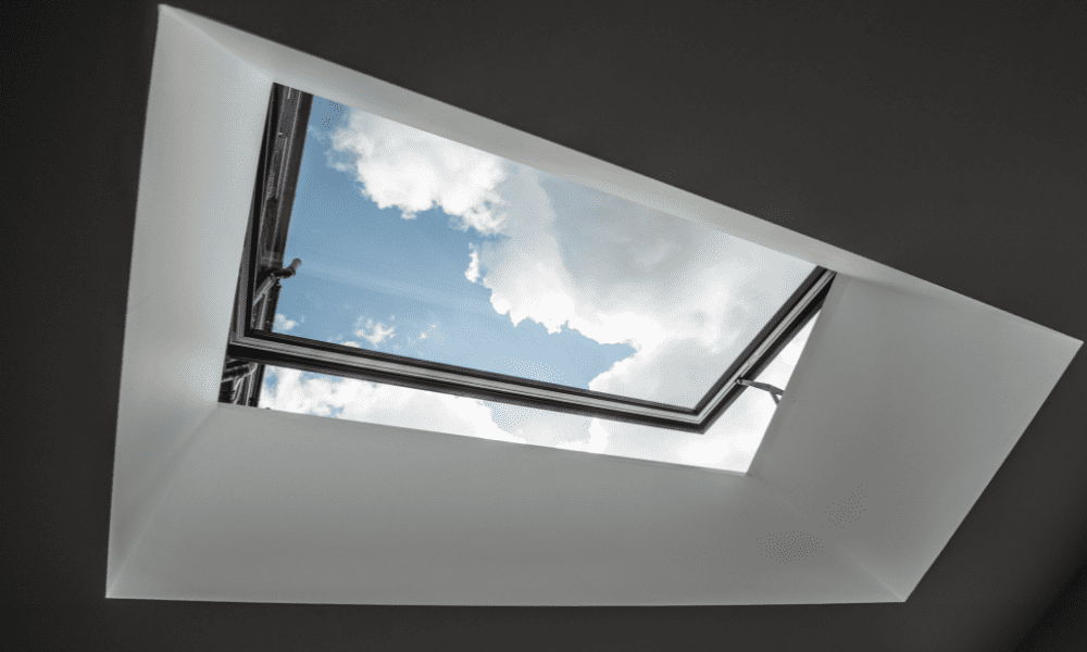 Visionvent skylight opened, looking from inside at the blue sky; installed for ventilation and natural daylight.